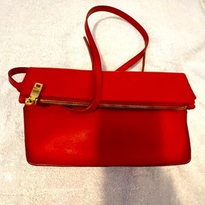 J Crew red leather cross body bag with fold over magnetic zipper closure.